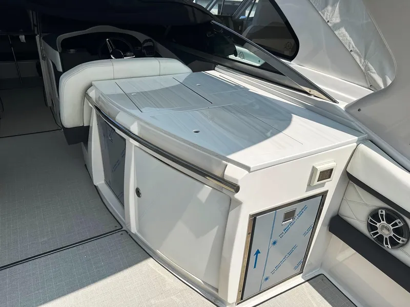 Slide: The Image of 2025 Regal 3300 boat interior with white cabinetry and seating. - 6