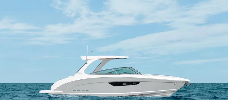 Slide: The Image of 2025 Regal 3300 boat cruising on open water under a clear sky. - 16