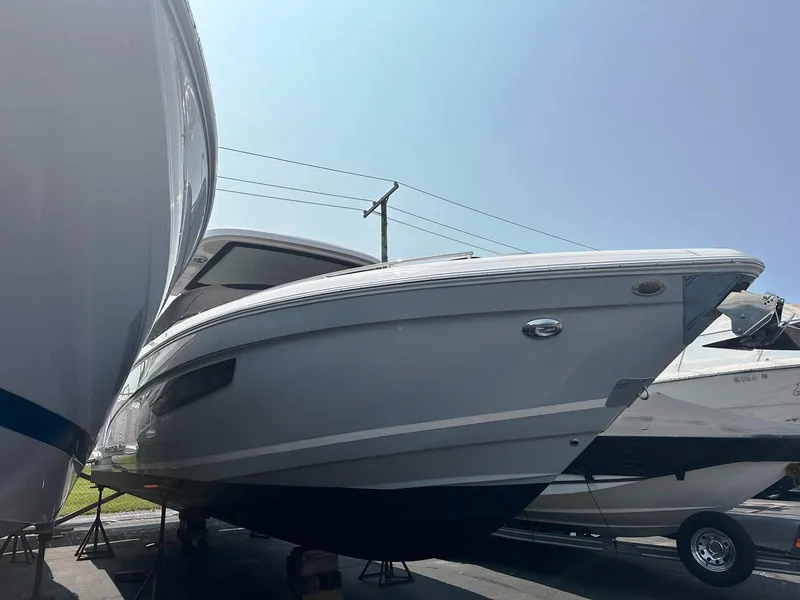 Slide: The Image of 2025 Regal 3300 boat on display in a marina. - 2