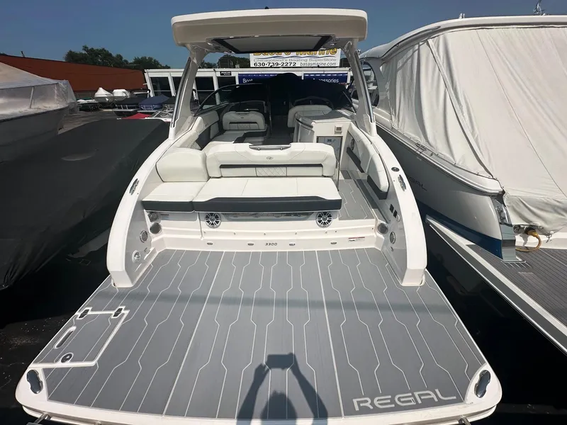 Slide: The Image of 2025 Regal 3300 luxury motorboat with spacious deck and seating area. - 3