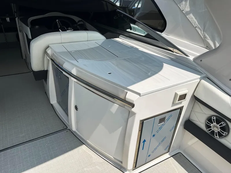 Slide: The Image of 2025 Regal 3300 boat interior with modern white cabinetry and seating. - 7