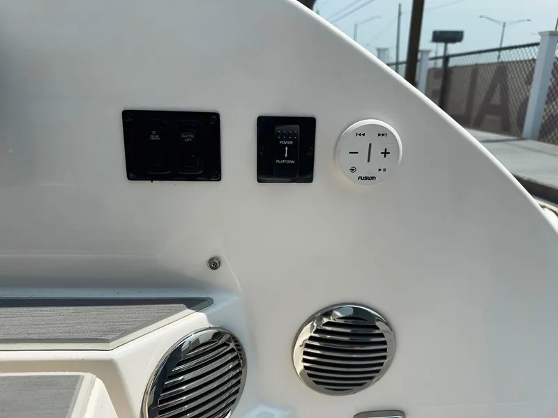Slide: The Image of Control panel of a 2025 Regal 3300 boat with switches and speakers. - 9