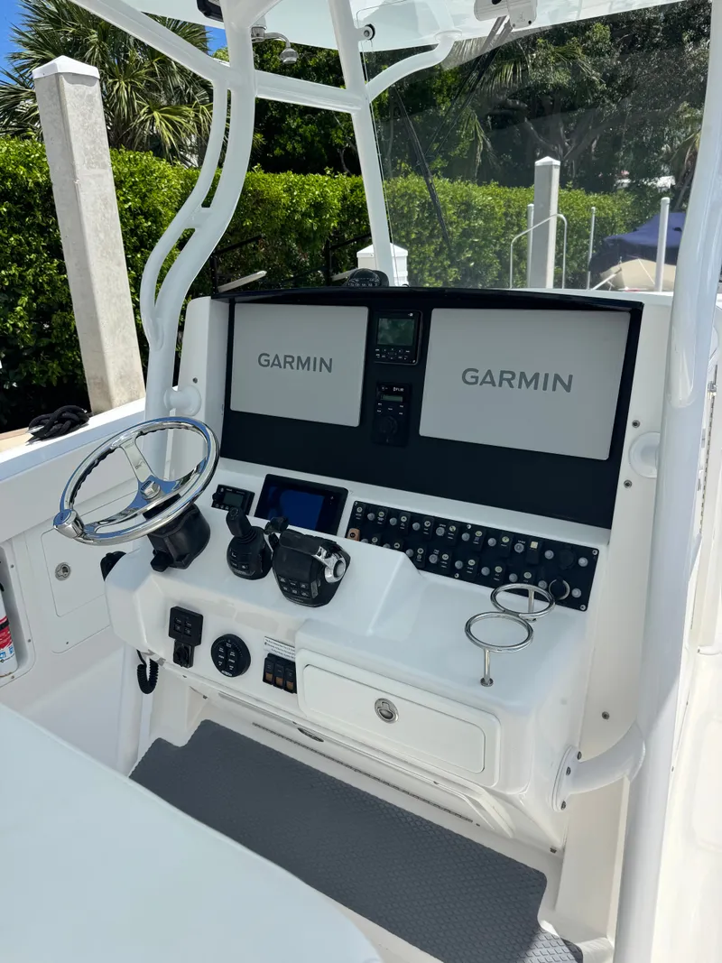 Slide: The Image of The image shows the helm of a 2015 Southport 33 boat with Garmin screens. - 24