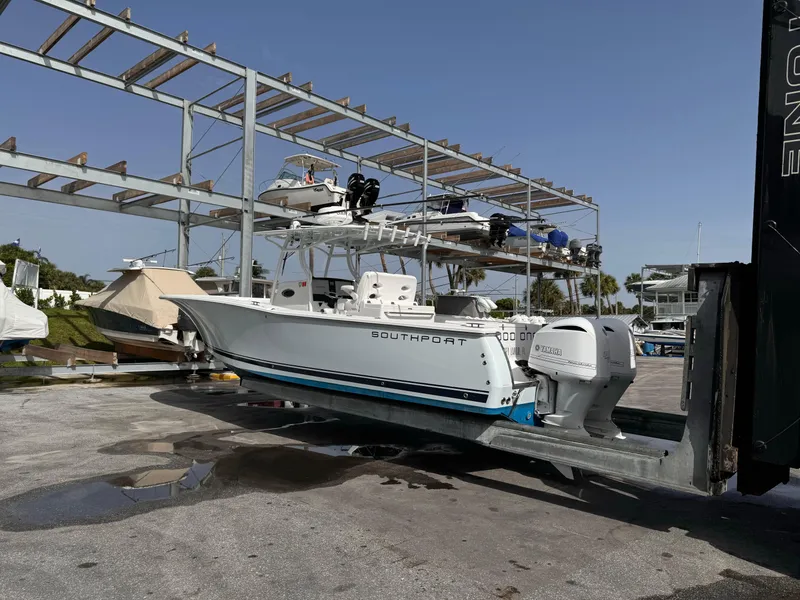 Slide: The Image of 2015 Southport 33 boat with twin Yamaha engines in a marina. - 2