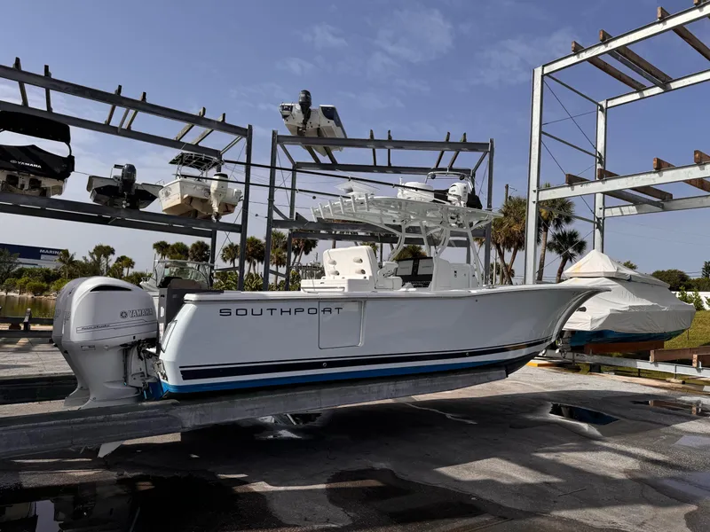 Slide: The Image of A 2015 Southport 33 boat is on a dry dock. It features a Yamaha outboard motor. - 2