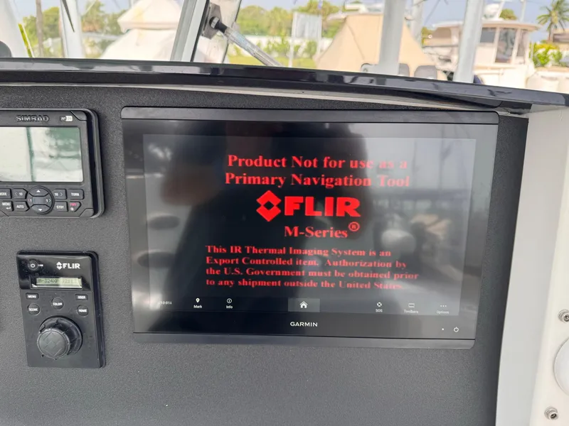 Slide: The Image of A Garmin screen displays a FLIR warning. Nearby are a radio and a FLIR control panel. - 12
