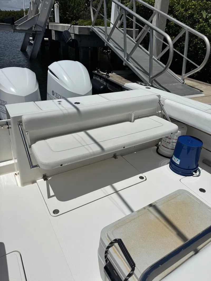 Slide: The Image of The image shows the stern of a 2015 Southport 33 boat with two engines. - 26