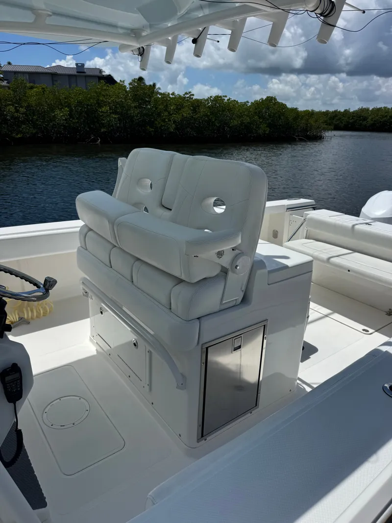 Slide: The Image of The image shows the cockpit of a 2015 Southport 33 boat with white cushioned seats. - 18