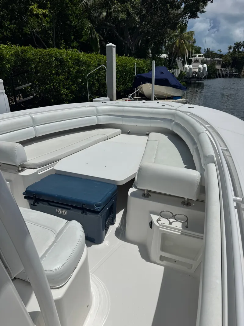 Slide: The Image of The image shows the cockpit of a 2015 Southport 33 boat with white seating and a table. - 20