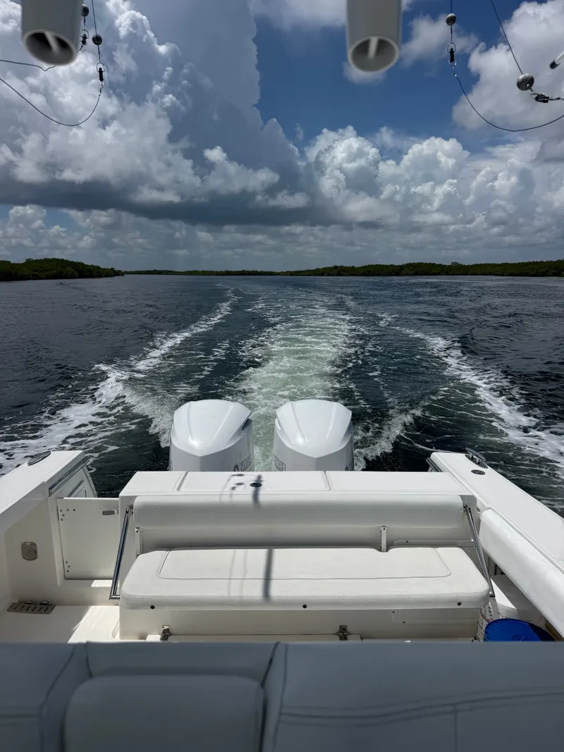 Slide: The Image of Rear view of a 2015 Southport 33 boat with twin engines on the water. - 30