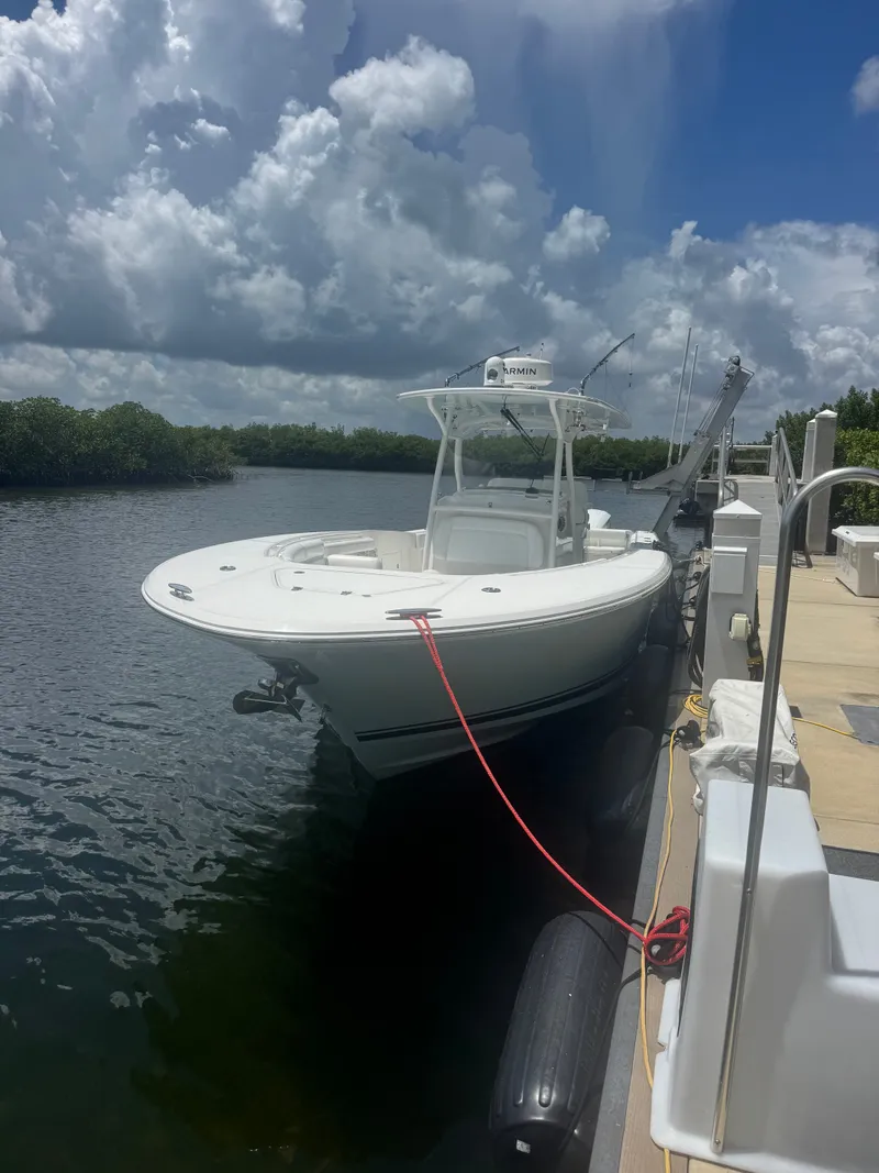 Slide: The Image of 2015 Southport 33 docked under a cloudy sky. - 14