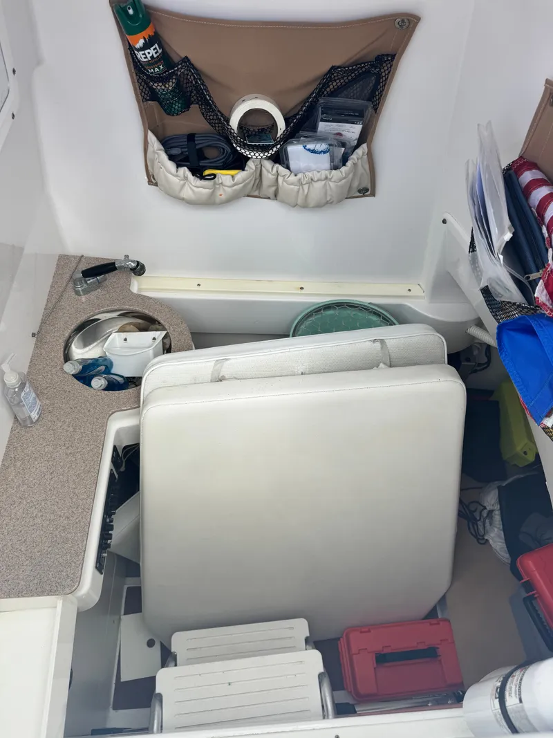 Slide: The Image of The interior of a 2015 Southport 33 boat with storage and seating. - 22