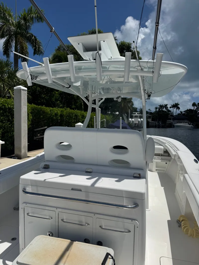 Slide: The Image of The image shows a 2015 Southport 33 boat with a spacious deck and fishing rod holders. - 27