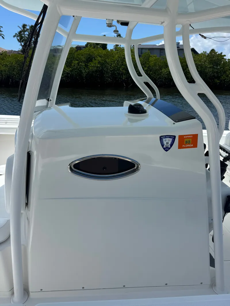 Slide: The Image of The image shows the helm of a 2015 Southport 33 boat with a white console. - 17