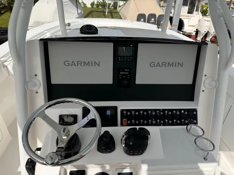 Slide: The Image of Southport 33 boat dashboard with Garmin navigation system, steering wheel, and control panel. - 9