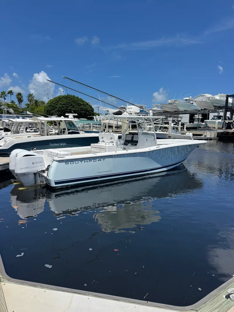 The Image of A 2015 Southport 33 boat is docked in the water on a sunny day at the marina. - 0
