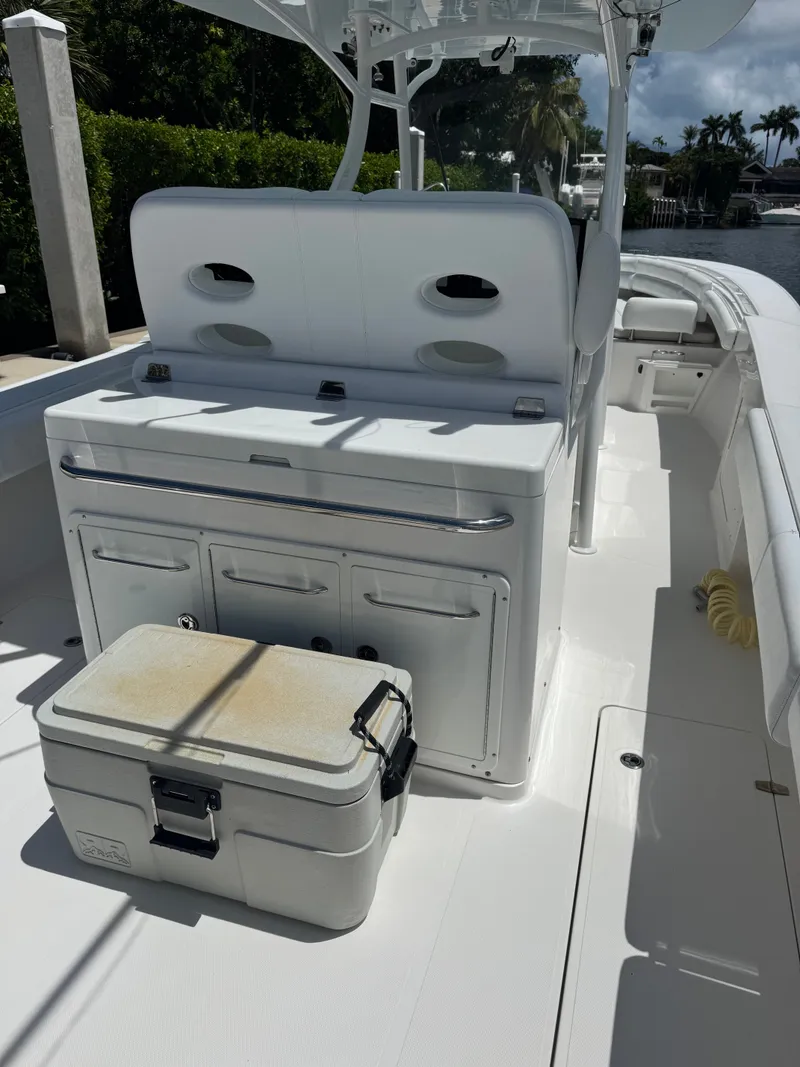 Slide: The Image of The image shows the cockpit of a 2015 Southport 33 boat with white seating and storage. - 19
