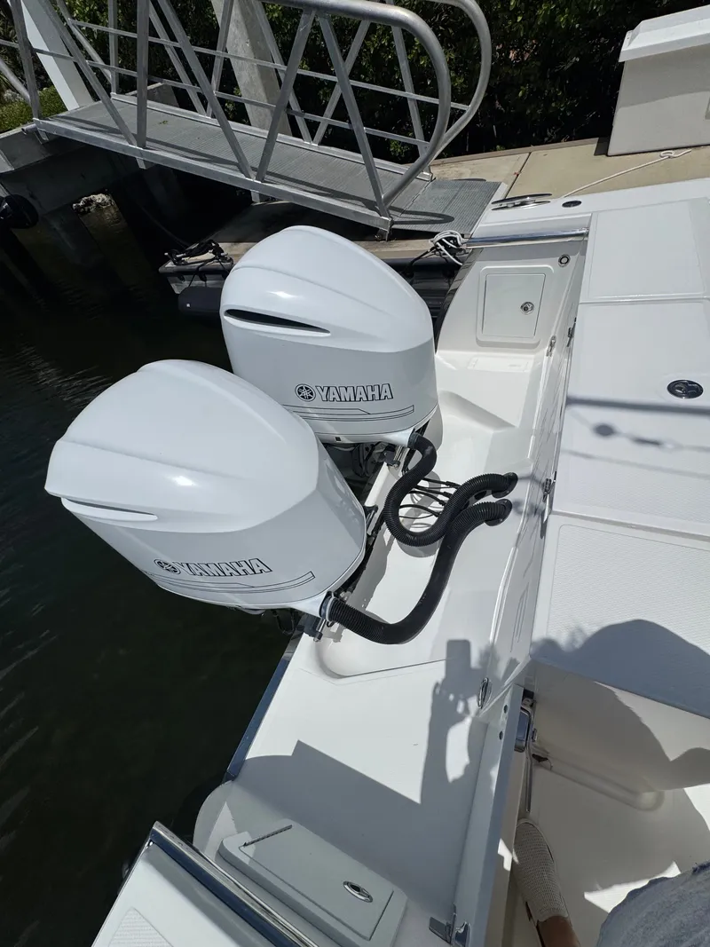 Slide: The Image of Two Yamaha outboard engines on a Southport 33 boat, docked at a pier. - 28
