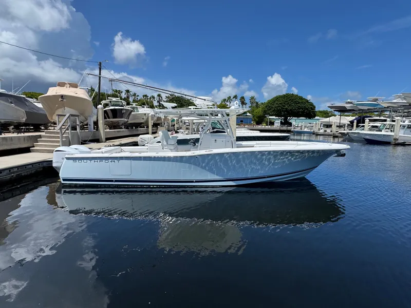 Slide: The Image of A 2015 Southport 33 boat is docked in the water on a sunny day at the marina. - 1