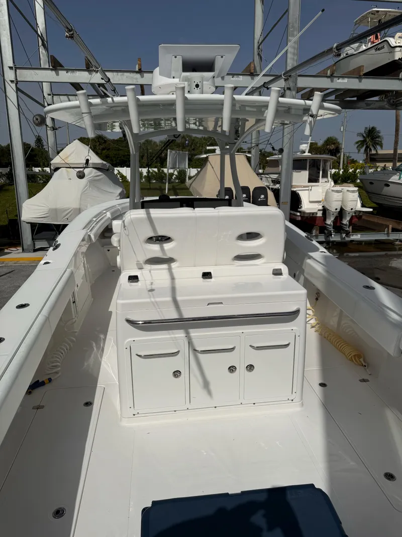 Slide: The Image of The image shows the cockpit of a 2015 Southport 33 boat with white interior and fishing rod holders. - 8