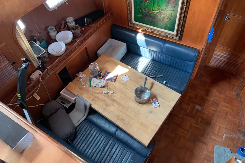 Slide: The Image of Interior of 1984 Jefferson 45 Motor Yacht with wooden table and blue seating. - 11