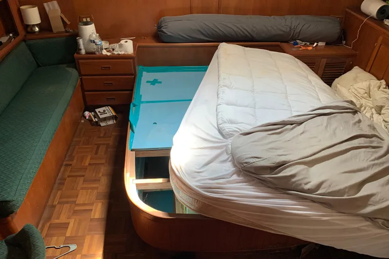 Slide: The Image of 1984 Jefferson 45 Motor Yacht cabin with bed, storage, and wooden interior. - 13