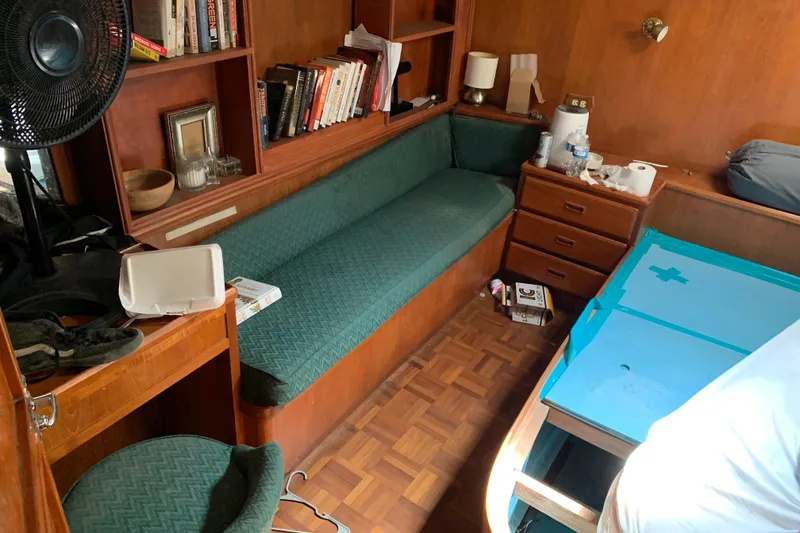 Slide: The Image of Interior of 1984 Jefferson 45 Motor Yacht with wooden furnishings and green upholstery. - 15