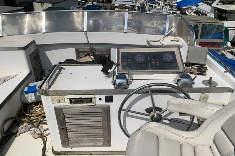 Slide: The Image of 1984 Jefferson 45 Motor Yacht helm with steering wheel and control panel. - 4