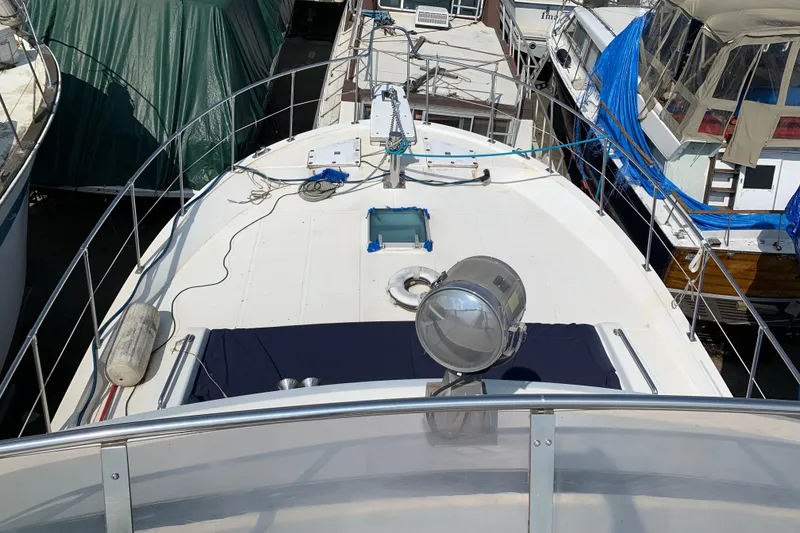 Slide: The Image of 1984 Jefferson 45 Motor Yacht docked, featuring spacious deck and nautical equipment. - 6