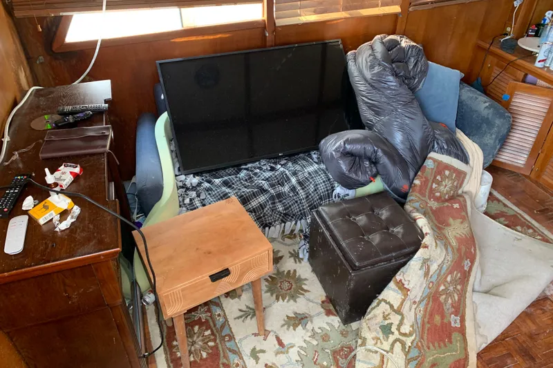Slide: The Image of Interior of a 1984 Jefferson 45 Motor Yacht with cluttered living space. - 7