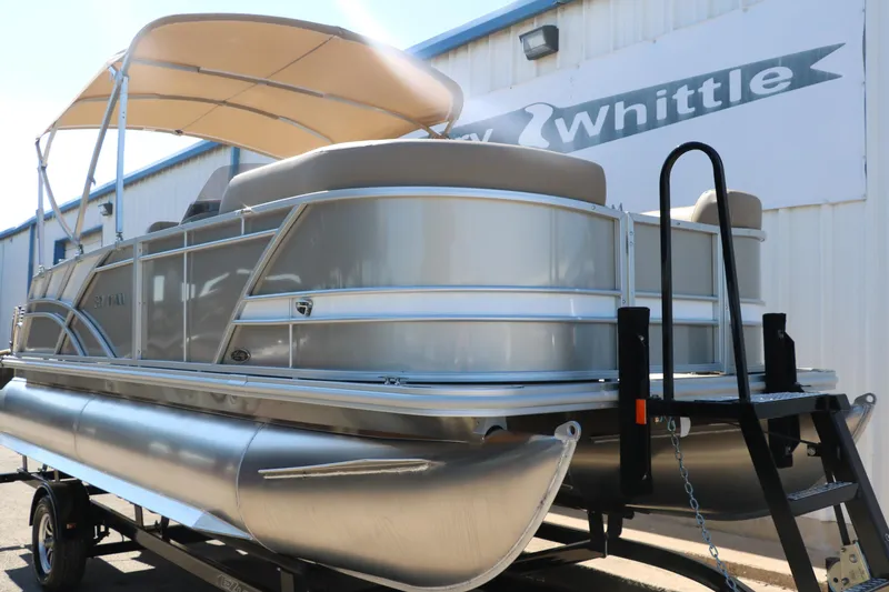 Slide: The Image of 2025 Sylvan Mirage 820 CLZ DH pontoon boat on trailer outside dealership. - 10