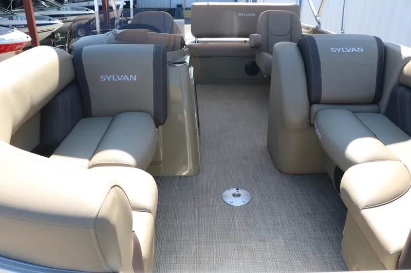 Slide: The Image of 2025 Sylvan Mirage 820 CLZ DH pontoon boat interior with beige seating. - 15