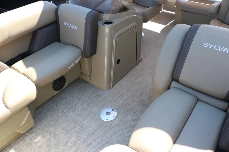 Slide: The Image of 2025 Sylvan Mirage 820 CLZ DH boat interior with beige and brown seating. - 18