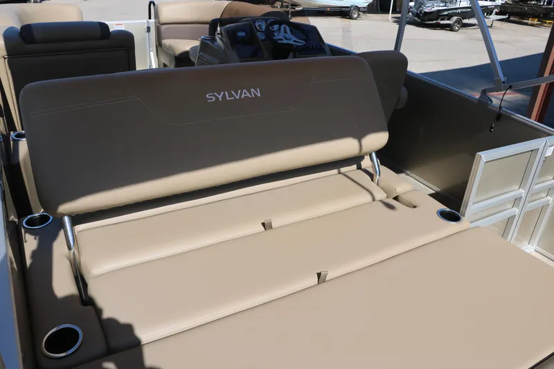 Slide: The Image of 2025 Sylvan Mirage 820 CLZ DH boat interior with tan seating and cup holders. - 20