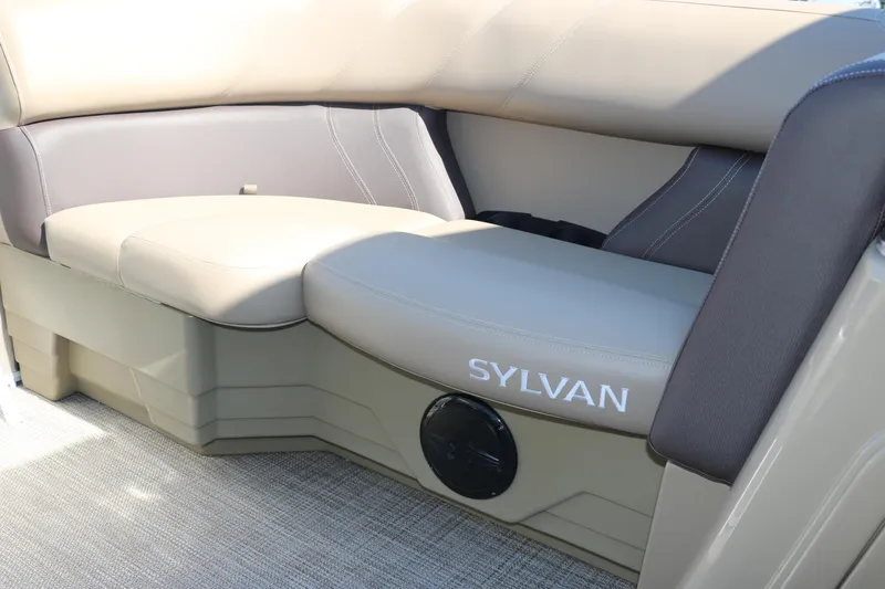 Slide: The Image of 2025 Sylvan Mirage 820 CLZ DH boat interior seating with logo. - 24