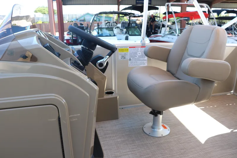 Slide: The Image of 2025 Sylvan Mirage 820 CLZ DH boat interior with captain's chair and control console. - 25
