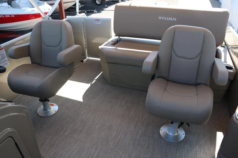 Slide: The Image of 2025 Sylvan Mirage 820 CLZ DH boat interior with beige seating and carpet. - 26
