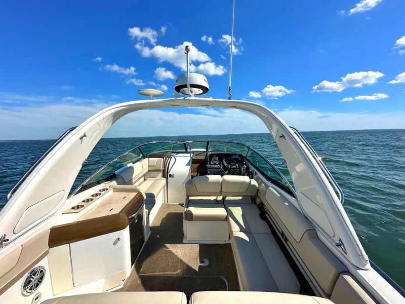 Slide: The Image of 2015 Formula 310 Sun Sport boat interior on open water under blue sky. - 10