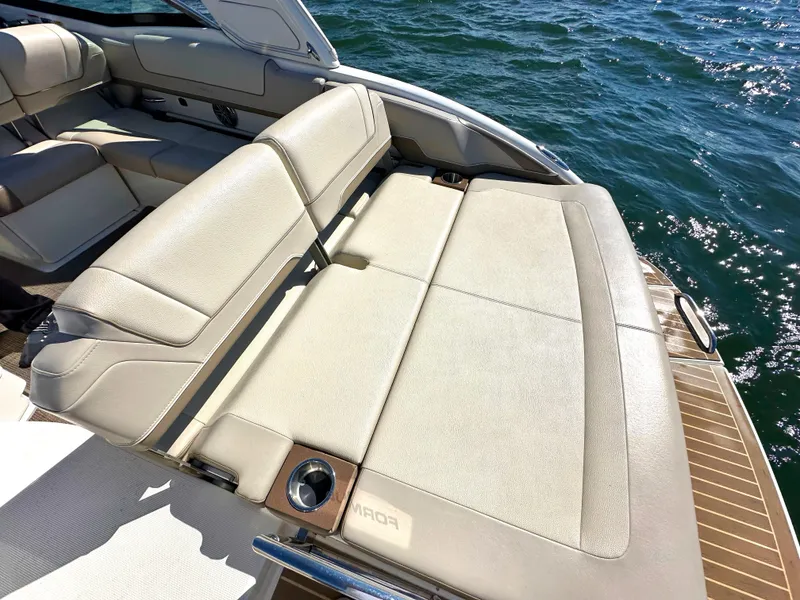 Slide: The Image of 2015 Formula 310 Sun Sport boat with beige leather seating on the water. - 11