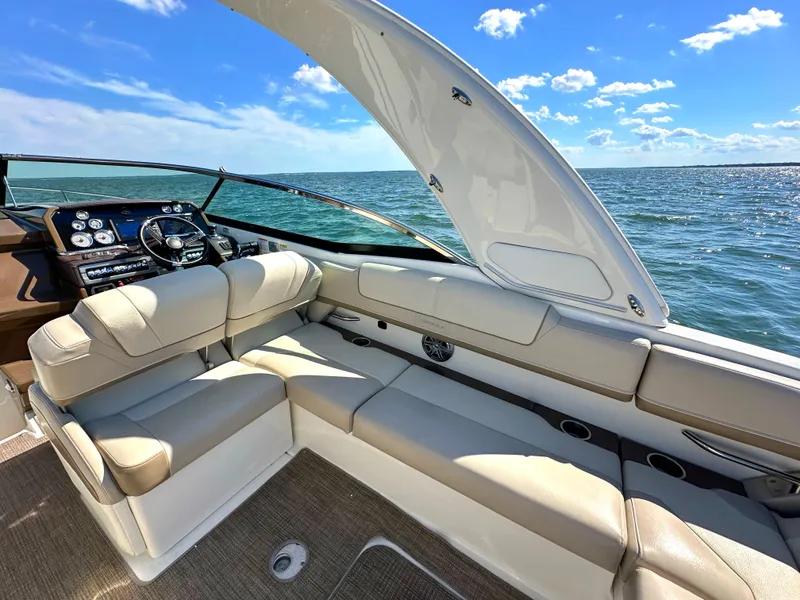 Slide: The Image of 2015 Formula 310 Sun Sport boat interior with beige seating and ocean view. - 14
