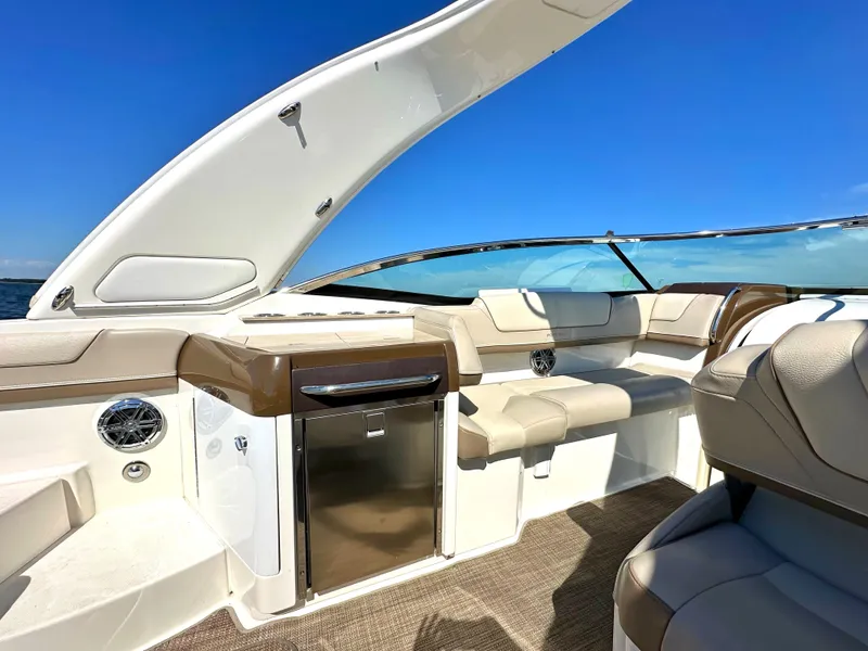 Slide: The Image of 2015 Formula 310 Sun Sport boat interior with seating and mini fridge. - 17