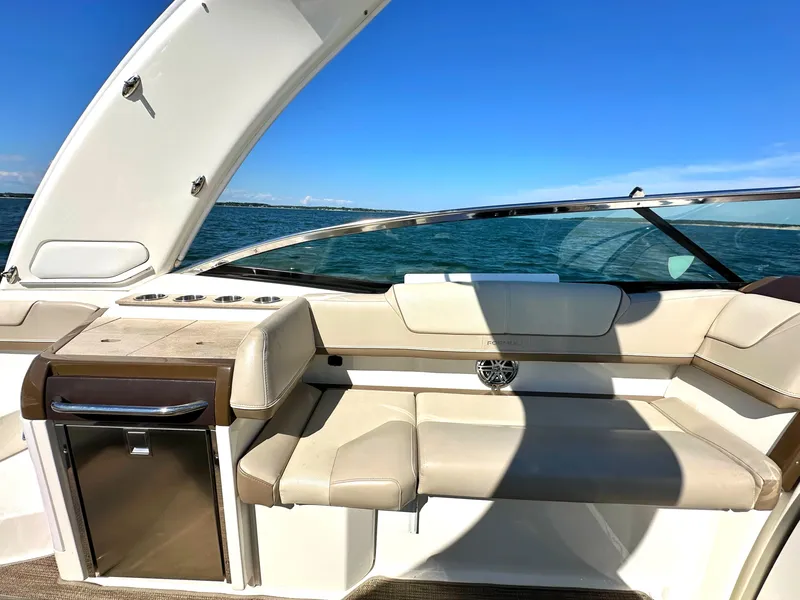 Slide: The Image of 2015 Formula 310 Sun Sport boat interior with beige seating and ocean view. - 19