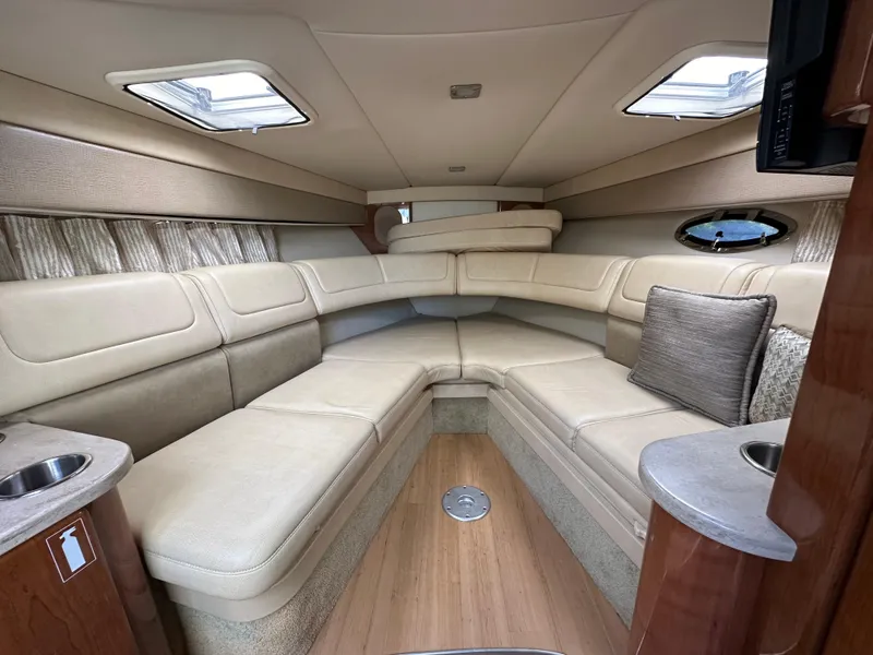 Slide: The Image of Interior of a 2015 Formula 310 Sun Sport boat with beige seating and wood accents. - 27