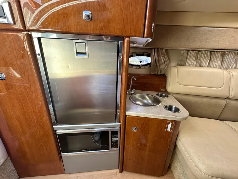 Slide: The Image of 2015 Formula 310 Sun Sport cabin with kitchenette and seating area. - 28