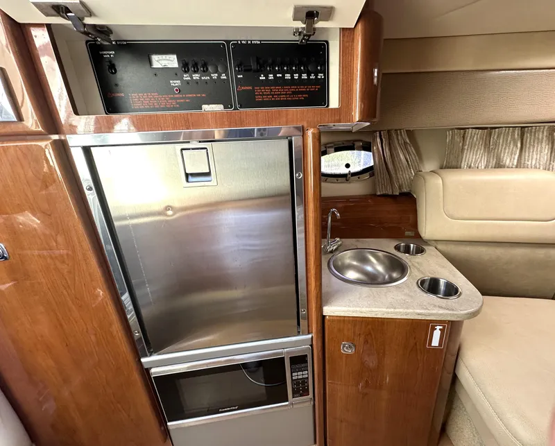 Slide: The Image of 2015 Formula 310 Sun Sport interior with kitchenette and control panel. - 29