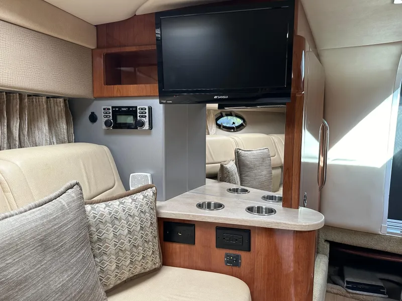 Slide: The Image of 2015 Formula 310 Sun Sport cabin interior with TV, seating, and control panel. - 32