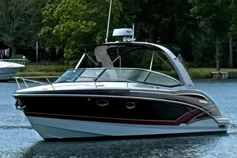 Slide: The Image of 2015 Formula 310 Sun Sport boat on a serene lake with lush greenery. - 4