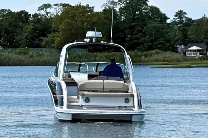 Slide: The Image of 2015 Formula 310 Sun Sport boat cruising on a serene lake. - 7
