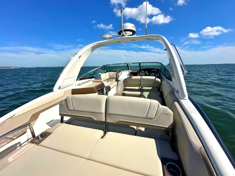 Slide: The Image of 2015 Formula 310 Sun Sport boat on open water, clear blue sky. - 8