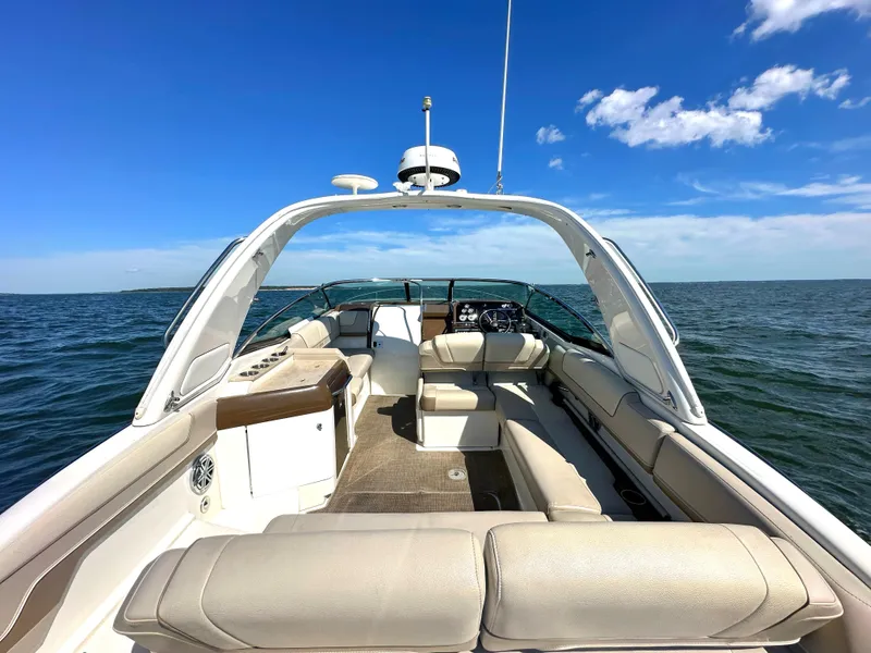 Slide: The Image of 2015 Formula 310 Sun Sport boat interior on open water under clear blue sky. - 9